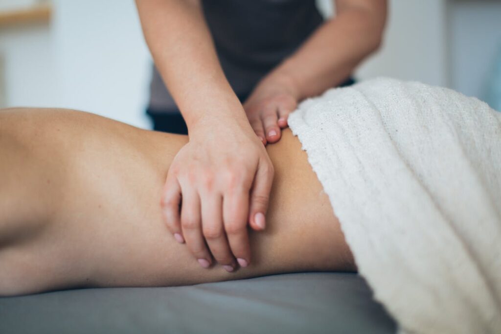 pexels-photo-3865793 Close-up of a woman receiving a therapeutic massage in a serene spa setting with a white towel.